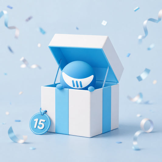 A white and light blue gift box with an open lid, revealing a blue spherical character with a white crescent mouth. A blue hanging tag on the front of the box reads “15.